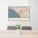 24x36 Santa Monica California Map Print Landscape Orientation in Woodblock Style Behind 2 Chairs Table and Potted Plant