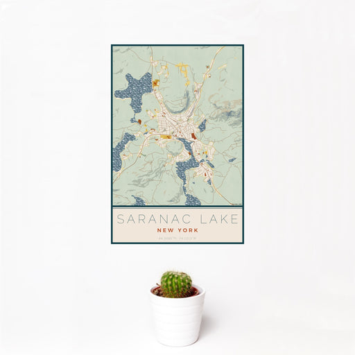 12x18 Saranac Lake New York Map Print Portrait Orientation in Woodblock Style With Small Cactus Plant in White Planter