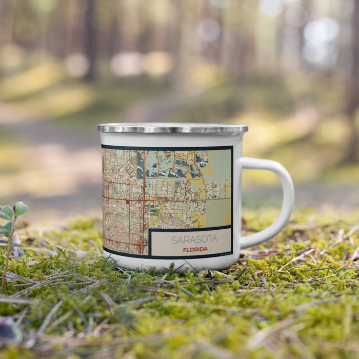 Right View Custom Sarasota Florida Map Enamel Mug in Woodblock on Grass With Trees in Background
