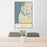 24x36 Saugatuck Michigan Map Print Portrait Orientation in Woodblock Style Behind 2 Chairs Table and Potted Plant