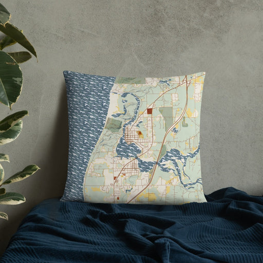 Custom Saugatuck Michigan Map Throw Pillow in Woodblock on Bedding Against Wall