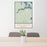 24x36 Sayner Wisconsin Map Print Portrait Orientation in Woodblock Style Behind 2 Chairs Table and Potted Plant