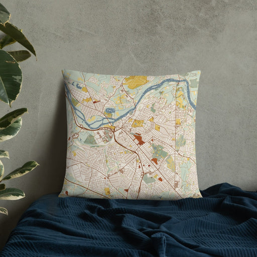 Custom Schenectady New York Map Throw Pillow in Woodblock on Bedding Against Wall