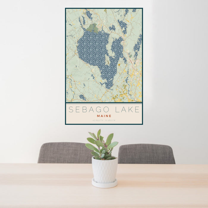 24x36 Sebago Lake Maine Map Print Portrait Orientation in Woodblock Style Behind 2 Chairs Table and Potted Plant