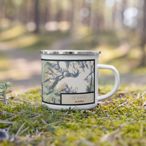 Right View Custom Seward Alaska Map Enamel Mug in Woodblock on Grass With Trees in Background