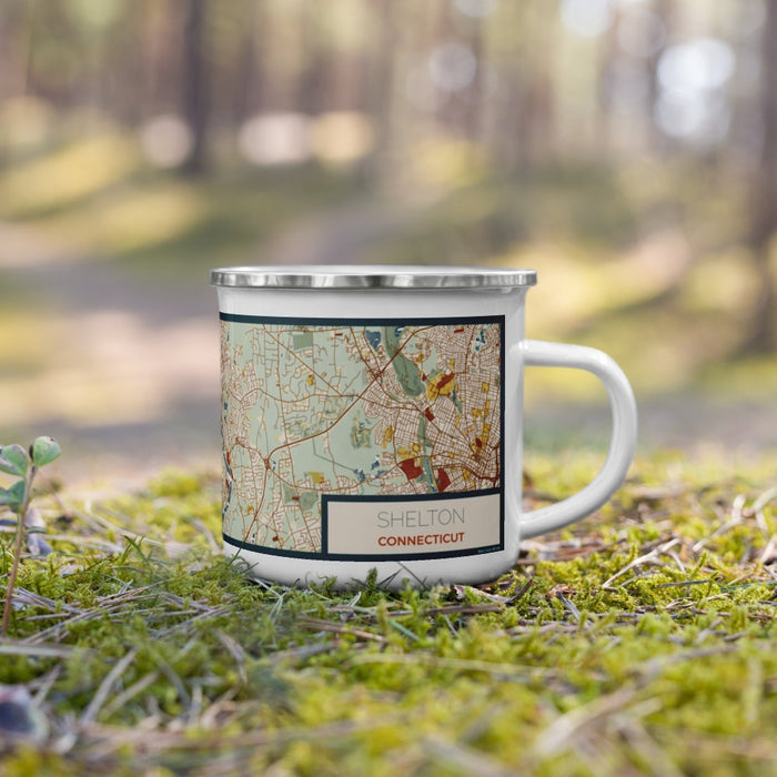 Right View Custom Shelton Connecticut Map Enamel Mug in Woodblock on Grass With Trees in Background