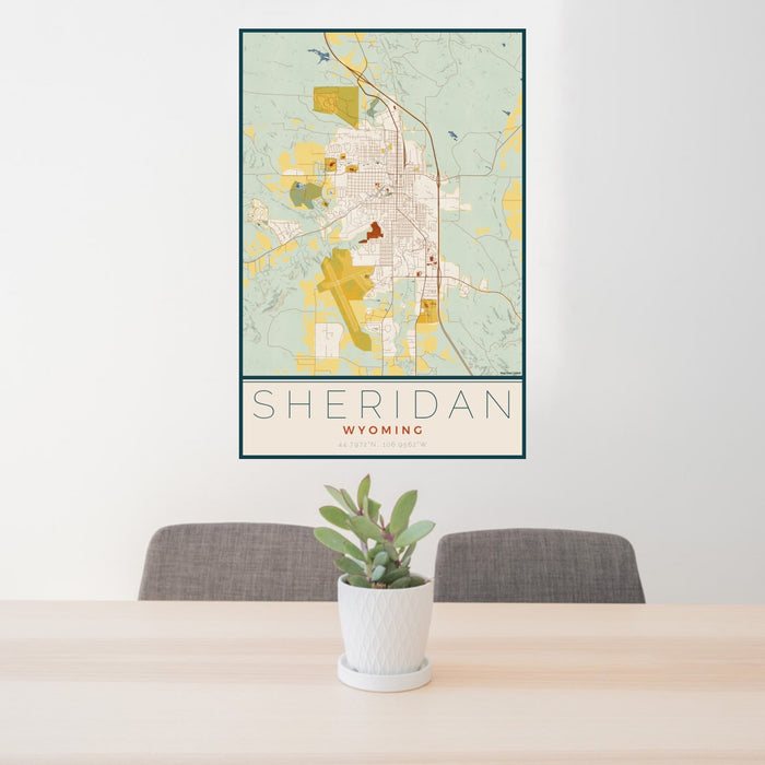 24x36 Sheridan Wyoming Map Print Portrait Orientation in Woodblock Style Behind 2 Chairs Table and Potted Plant