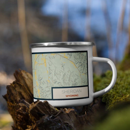 Right View Custom Sheridan Wyoming Map Enamel Mug in Woodblock on Grass With Trees in Background