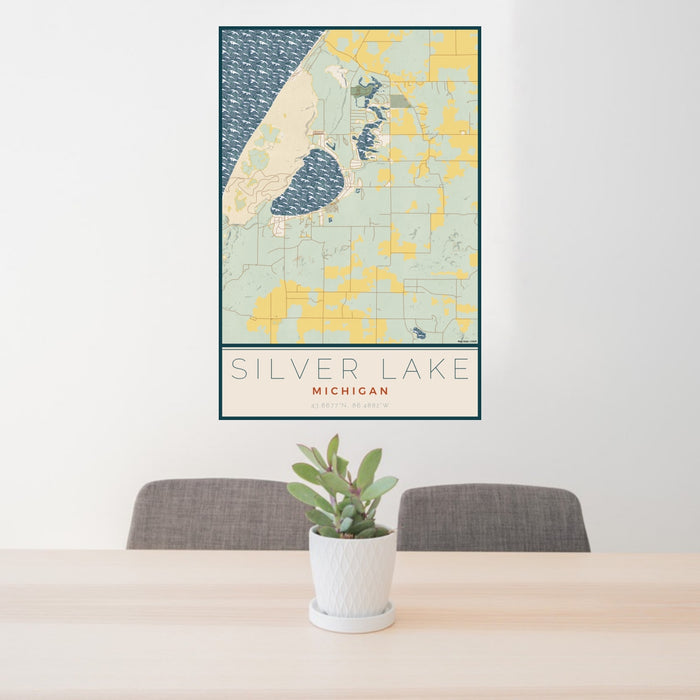 24x36 Silver Lake Michigan Map Print Portrait Orientation in Woodblock Style Behind 2 Chairs Table and Potted Plant