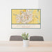 24x36 Sioux Falls South Dakota Map Print Landscape Orientation in Woodblock Style Behind 2 Chairs Table and Potted Plant