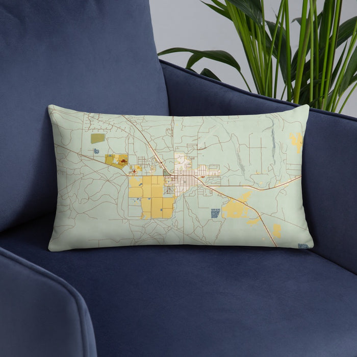 Custom Sisters Oregon Map Throw Pillow in Woodblock on Blue Colored Chair