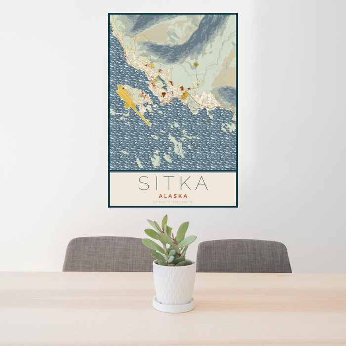 24x36 Sitka Alaska Map Print Portrait Orientation in Woodblock Style Behind 2 Chairs Table and Potted Plant