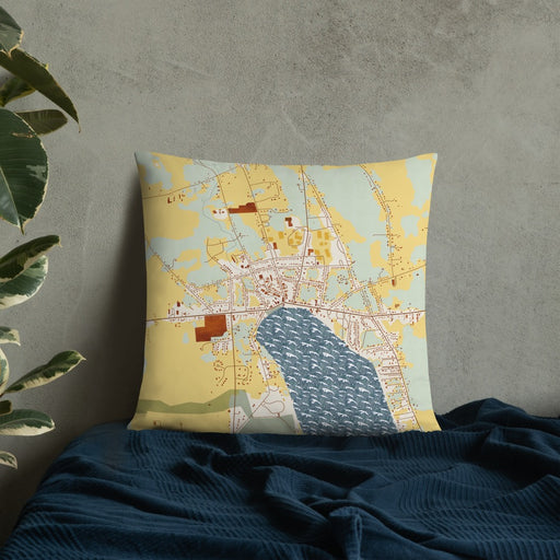 Custom Skaneateles New York Map Throw Pillow in Woodblock on Bedding Against Wall