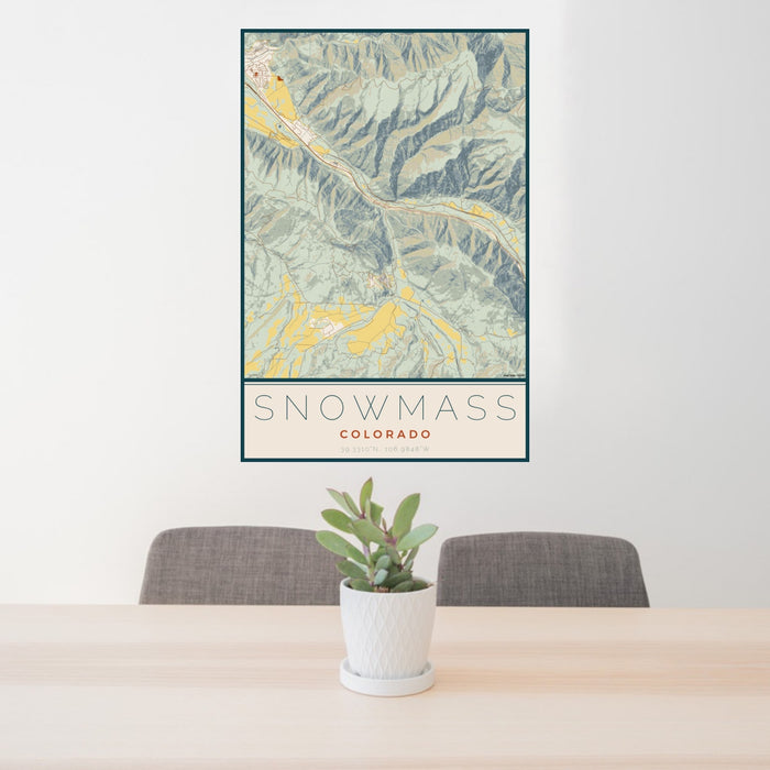 24x36 Snowmass Colorado Map Print Portrait Orientation in Woodblock Style Behind 2 Chairs Table and Potted Plant