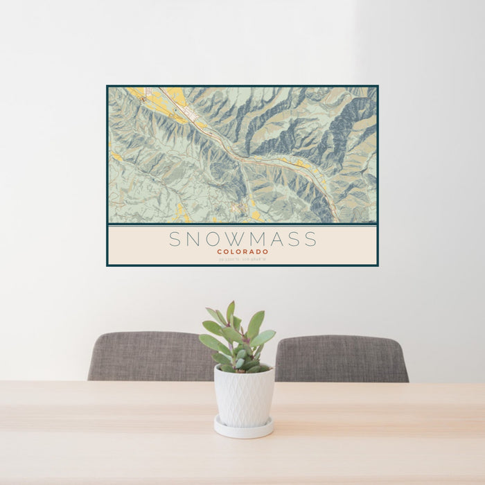 24x36 Snowmass Colorado Map Print Landscape Orientation in Woodblock Style Behind 2 Chairs Table and Potted Plant