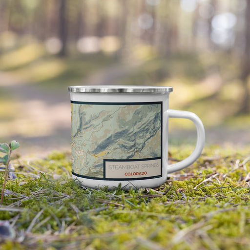 Right View Custom Steamboat Springs Colorado Map Enamel Mug in Woodblock on Grass With Trees in Background