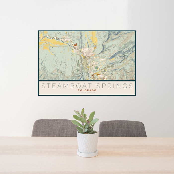 24x36 Steamboat Springs Colorado Map Print Landscape Orientation in Woodblock Style Behind 2 Chairs Table and Potted Plant