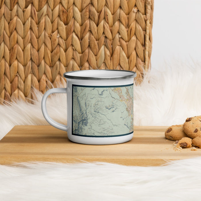 Left View Custom St. George Utah Map Enamel Mug in Woodblock on Table Top