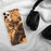 Custom Stowe Vermont Map Phone Case in Ember on Table with Black Headphones