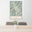 24x36 Sun Valley Idaho Map Print Portrait Orientation in Woodblock Style Behind 2 Chairs Table and Potted Plant