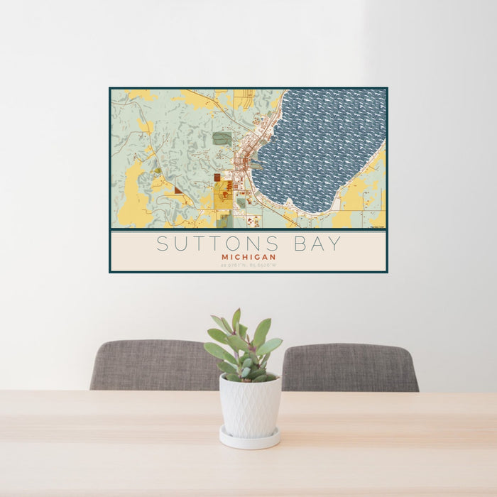 24x36 Suttons Bay Michigan Map Print Lanscape Orientation in Woodblock Style Behind 2 Chairs Table and Potted Plant
