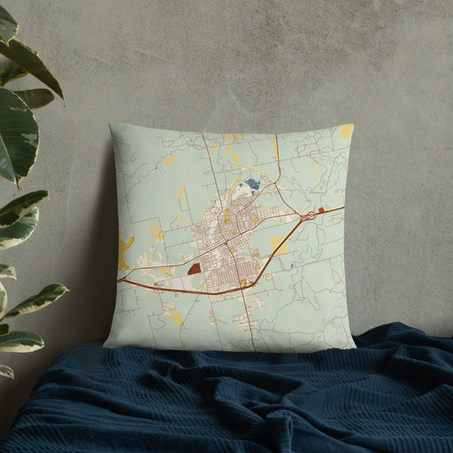 Custom Sweetwater Texas Map Throw Pillow in Woodblock on Bedding Against Wall