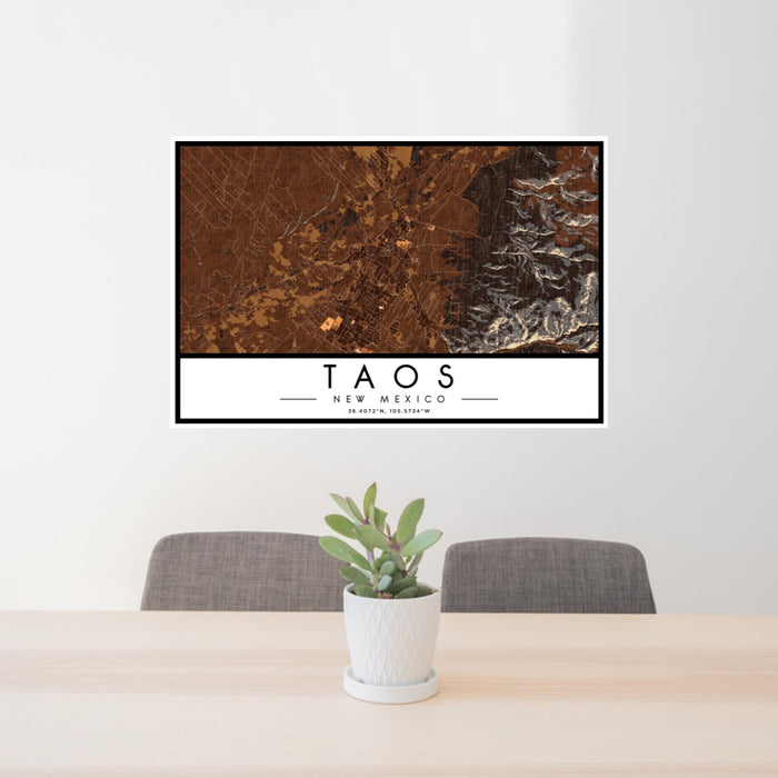 24x36 Taos New Mexico Map Print Lanscape Orientation in Ember Style Behind 2 Chairs Table and Potted Plant