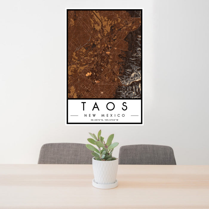 24x36 Taos New Mexico Map Print Portrait Orientation in Ember Style Behind 2 Chairs Table and Potted Plant