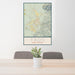 24x36 Taos New Mexico Map Print Portrait Orientation in Woodblock Style Behind 2 Chairs Table and Potted Plant