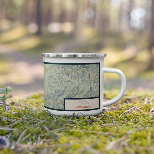 Right View Custom Taos New Mexico Map Enamel Mug in Woodblock on Grass With Trees in Background