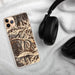 Custom Telluride Colorado Map Phone Case in Ember on Table with Black Headphones