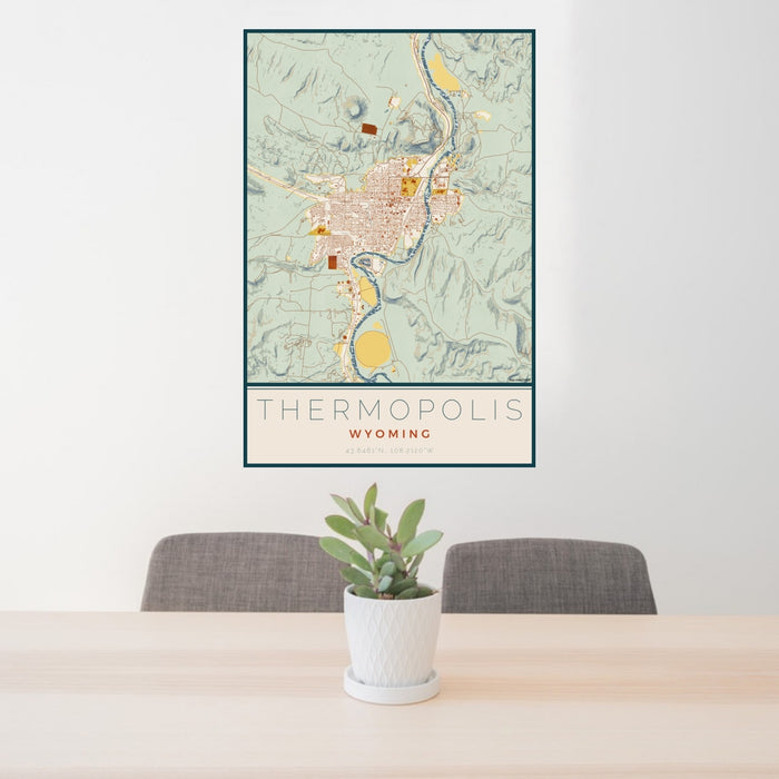 24x36 Thermopolis Wyoming Map Print Portrait Orientation in Woodblock Style Behind 2 Chairs Table and Potted Plant
