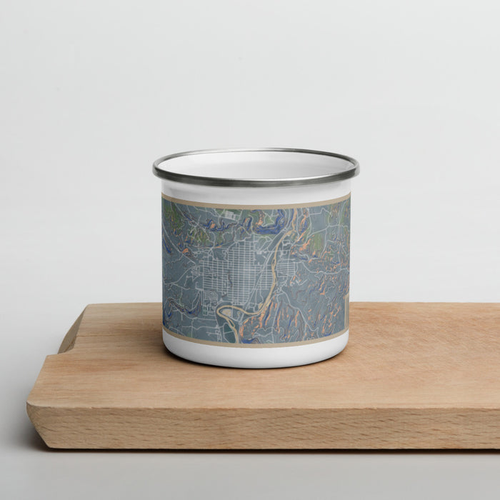 Front View Custom Thermopolis Wyoming Map Enamel Mug in Afternoon on Cutting Board
