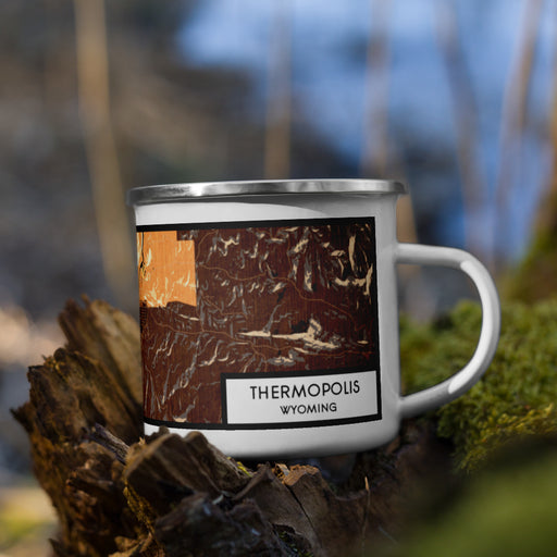 Right View Custom Thermopolis Wyoming Map Enamel Mug in Ember on Grass With Trees in Background
