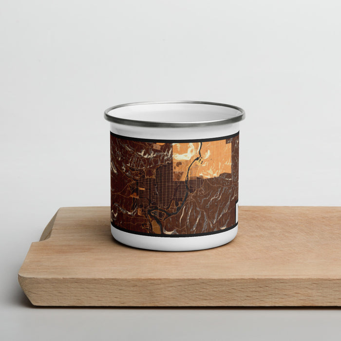 Front View Custom Thermopolis Wyoming Map Enamel Mug in Ember on Cutting Board