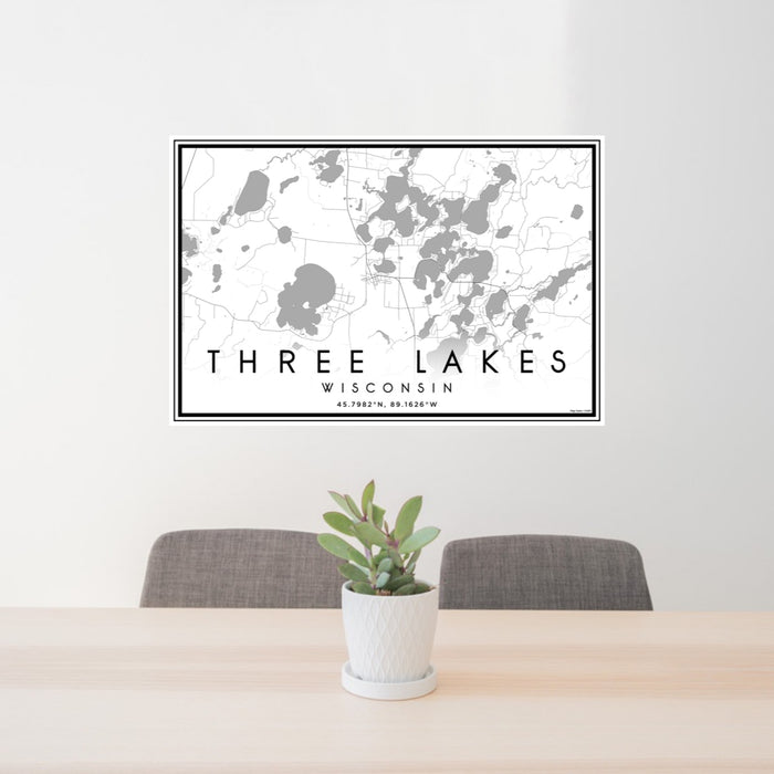 24x36 Three Lakes Wisconsin Map Print Landscape Orientation in Classic Style Behind 2 Chairs Table and Potted Plant