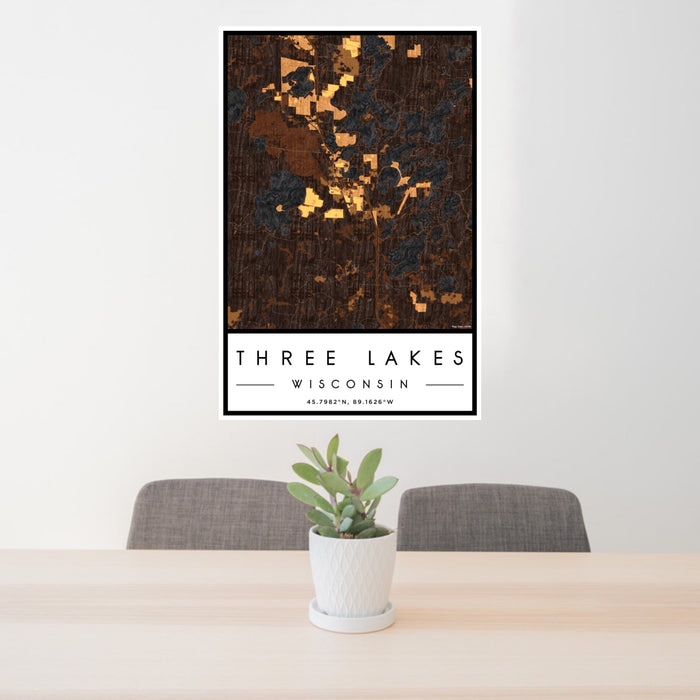 24x36 Three Lakes Wisconsin Map Print Portrait Orientation in Ember Style Behind 2 Chairs Table and Potted Plant