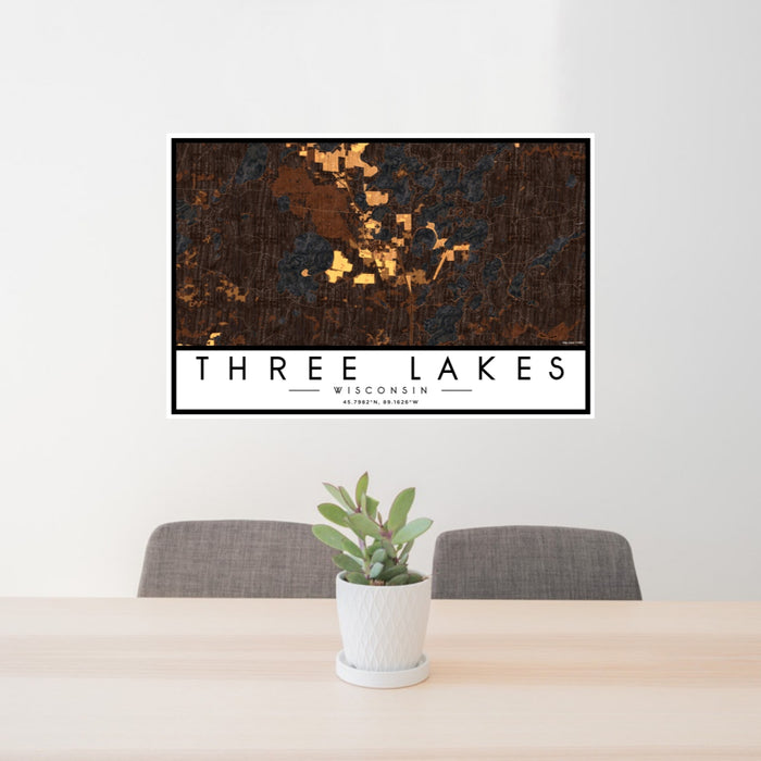 24x36 Three Lakes Wisconsin Map Print Landscape Orientation in Ember Style Behind 2 Chairs Table and Potted Plant