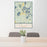 24x36 Three Lakes Wisconsin Map Print Portrait Orientation in Woodblock Style Behind 2 Chairs Table and Potted Plant