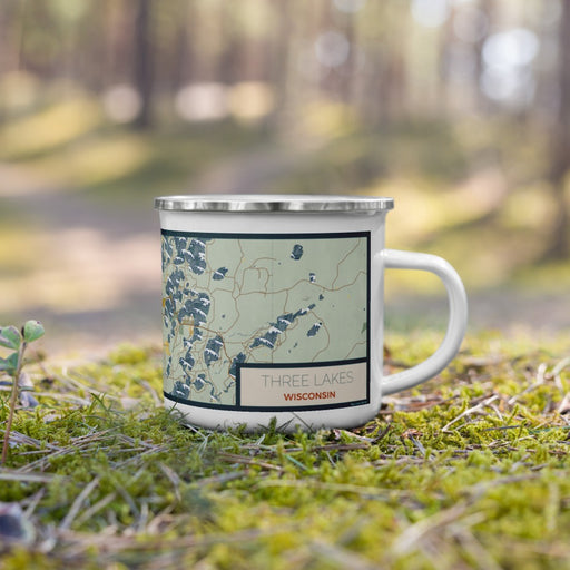 Right View Custom Three Lakes Wisconsin Map Enamel Mug in Woodblock on Grass With Trees in Background