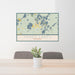 24x36 Three Lakes Wisconsin Map Print Landscape Orientation in Woodblock Style Behind 2 Chairs Table and Potted Plant