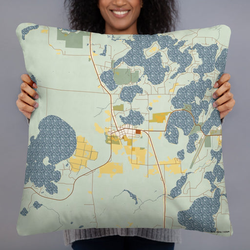 Person holding 22x22 Custom Three Lakes Wisconsin Map Throw Pillow in Woodblock