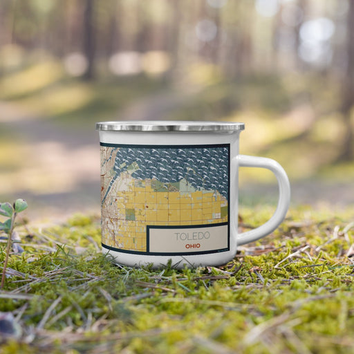 Right View Custom Toledo Ohio Map Enamel Mug in Woodblock on Grass With Trees in Background