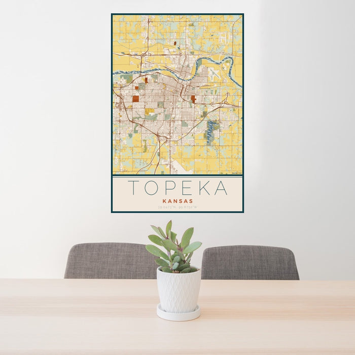 24x36 Topeka Kansas Map Print Portrait Orientation in Woodblock Style Behind 2 Chairs Table and Potted Plant