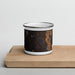 Front View Custom Topo Pines New Hampshire Map Enamel Mug in Ember on Cutting Board