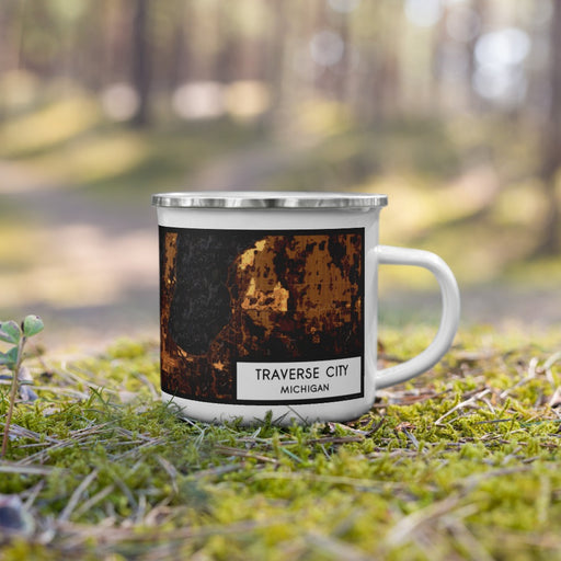 Right View Custom Traverse City Michigan Map Enamel Mug in Ember on Grass With Trees in Background