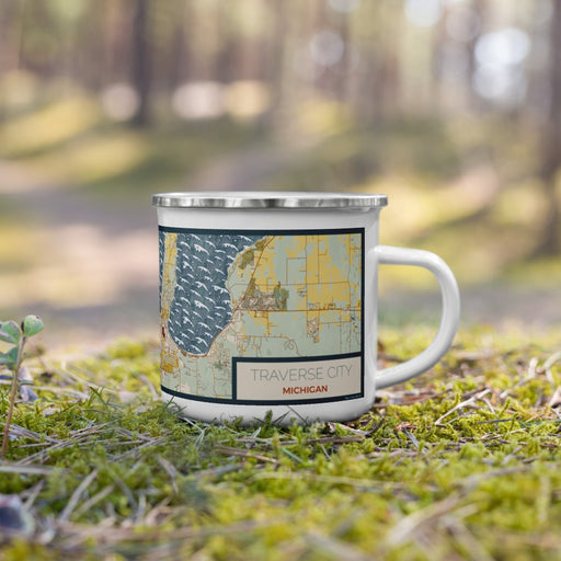 Right View Custom Traverse City Michigan Map Enamel Mug in Woodblock on Grass With Trees in Background