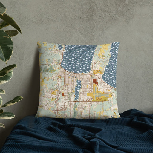 Custom Traverse City Michigan Map Throw Pillow in Woodblock on Bedding Against Wall