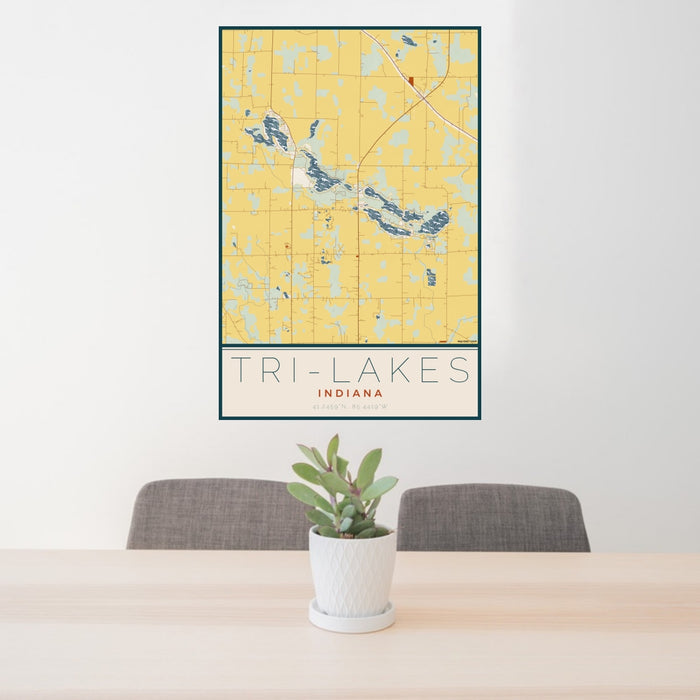 24x36 Tri-Lakes Indiana Map Print Portrait Orientation in Woodblock Style Behind 2 Chairs Table and Potted Plant