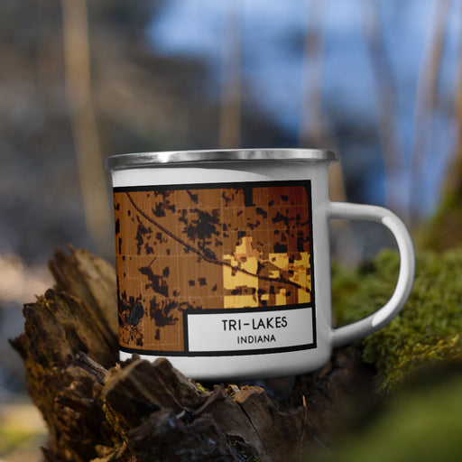 Right View Custom Tri-Lakes Indiana Map Enamel Mug in Ember on Grass With Trees in Background
